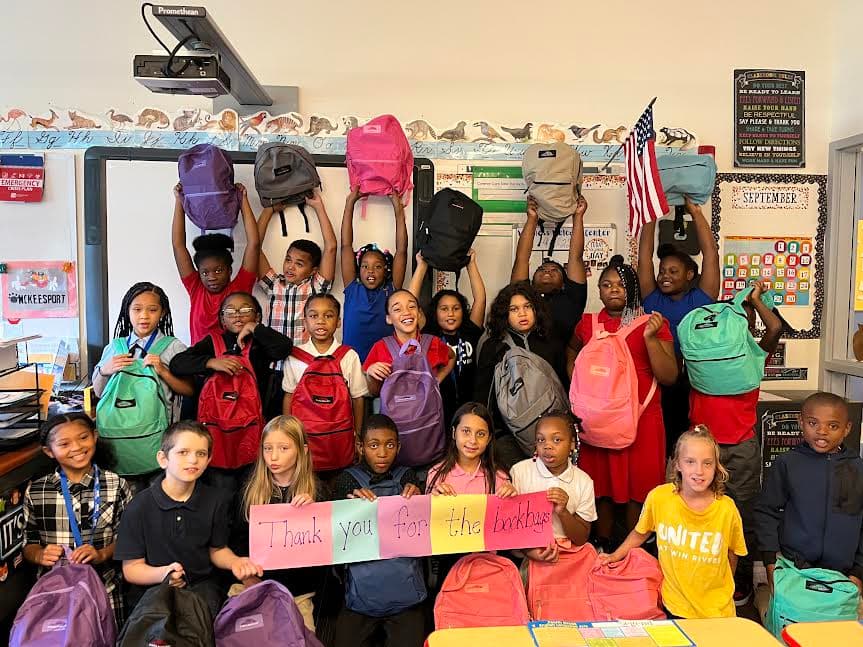 McKeesport Area School District students holding up backpacks with a Thank You sign